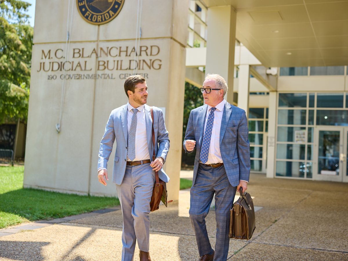 James and Mason Barnes walking outside the M.C. Blanchard Judicial Building in downtown Pensacola