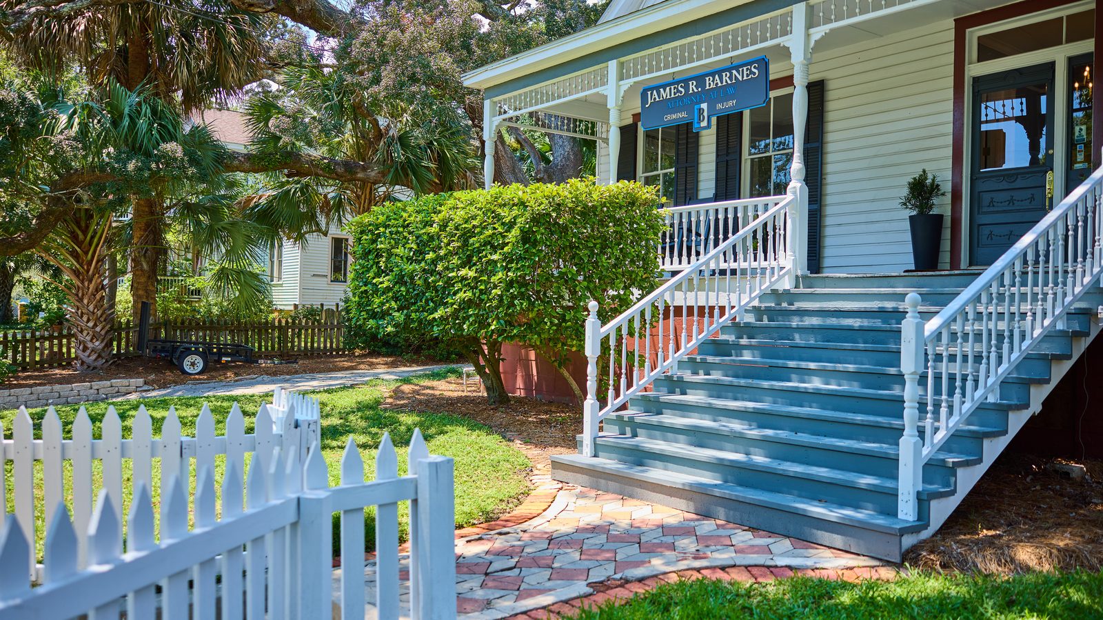 The James R. Barnes, Attorney at Law office at 816 E. La Rua Street, Pensacola: a white historic house with a picket fence