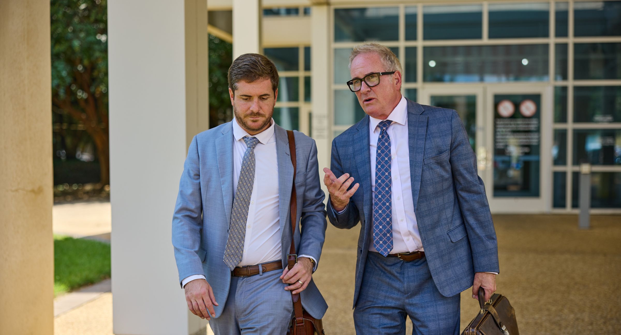 James and Mason Barnes walking to court in Pensacola, talking through a case